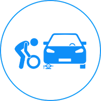 Icon showing a person changing a tire on a car.